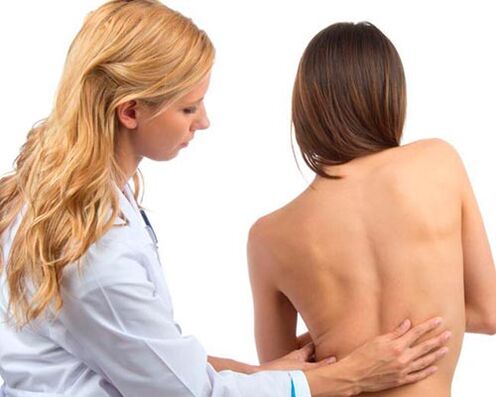 doctor examining the back for lower back pain